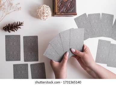 Woman Hands With Tarot Cards On The White Table