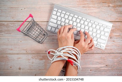 Woman Hands Tied With Network Cable With Supermarket Trolley, Shopping Addiction Concept.