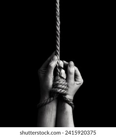 Woman hands tied with a rope over black background
