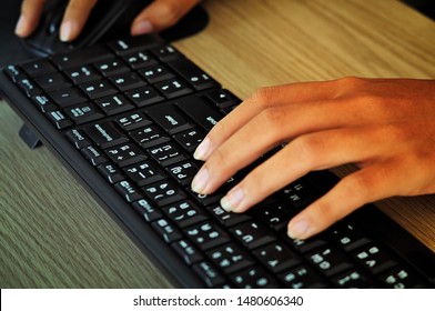 Woman Hands Are Typing On Black Keyboard And Clicking Mouse