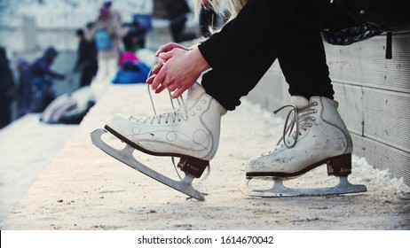 A Woman Hands Untie Her Figure Skates