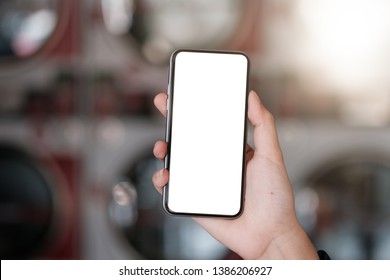 Woman hands using smartphone mockup at the laundromat shop
Laundry Shops. Blank screen mobile phone for graphic display montage - Powered by Shutterstock