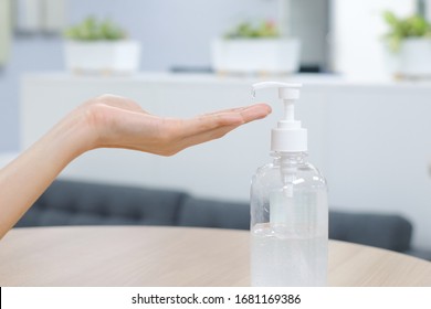 Woman Hands Using Wash Hand Sanitizer Gel Pump Dispenser. Clear Sanitizer In Pump Bottle, For Killing Germs, Bacteria And Virus.

