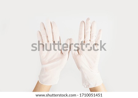 Woman hands wering rubber glove protection safety covid 19 white background