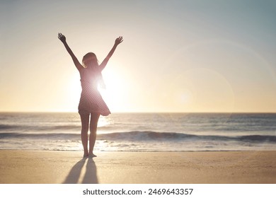 Woman, hands up and winner with silhouette at beach with sunset sky, mock up space and celebration. Girl, person and success with cheers, freedom and summer sunshine at dusk with goals by ocean - Powered by Shutterstock