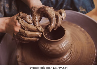 Woman hands working on pottery wheel and making a pot. - Shutterstock ID 1377692564