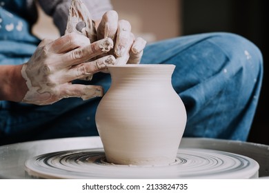 Woman hands working on pottery wheel and making a pot. - Shutterstock ID 2133824735