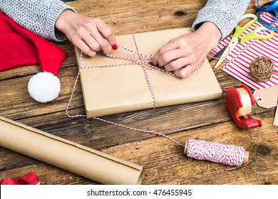 Woman Hands Wrapping Book For Christmas Present. Overhead View