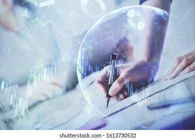 A woman hands writing information about stock market in notepad. Forex chart holograms in front. Concept of research. Double exposure