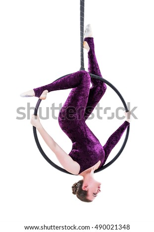 Woman hanging in aerial ring, isolated on white