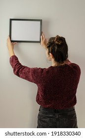 Woman Hanging Black Frame With White Background