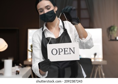 Woman Hanging Open Sign Onto Glass Door In Salon, Focus On Hands. Beauty Services During Coronavirus Quarantine