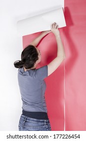 Woman Hanging Wallpaper. Decorating The Wall