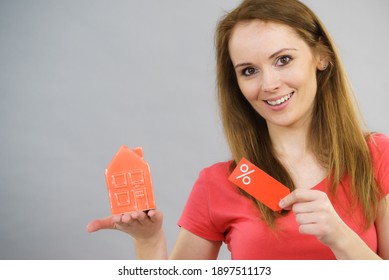 Woman Is Happy About Buying House In Affordable Price. Female Holding Small Red Home Model And Sale Percentage Sign. Reduced Housing Prices. Fall And Crisis Of Real Estate Market. Low Rent