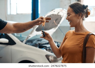 Woman, happy and giving keys in garage for repair, maintenance and vehicle inspection with mechanic. Customer, smile and car owner in workshop with satisfaction for quality or professional service - Powered by Shutterstock