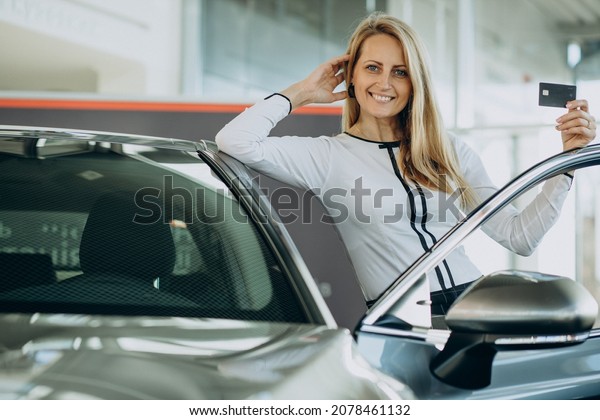 Woman happy just bought her\
new car