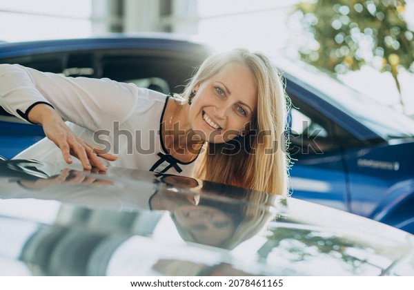Woman happy just bought her\
new car