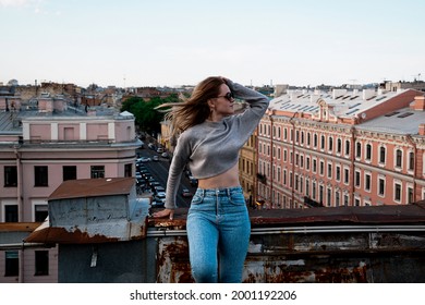 Woman Is Happy On The Roof Of Saint Petersburg, Russia. Cityscape View Over The Rooftops Of St. Petersburg.