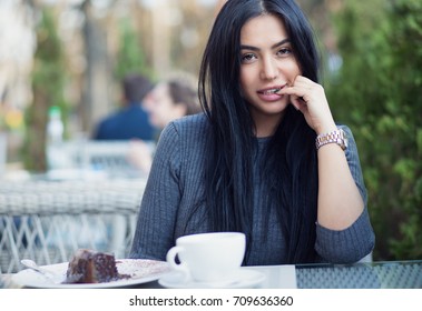 Woman Happy & Sexy. Closeup Portrait Beautiful Smiling Flirting Girl Student Hand On Lips Looking At You Camera Coffee Shop Background Multicultural Mixt Race Arabian Model Black Eyes Hair Gray Blouse