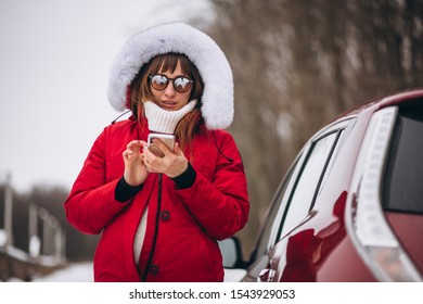 Woman Happy Talking On The Phone Outside By Car In Winter