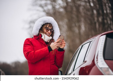 Woman Happy Talking On The Phone Outside By Car In Winter