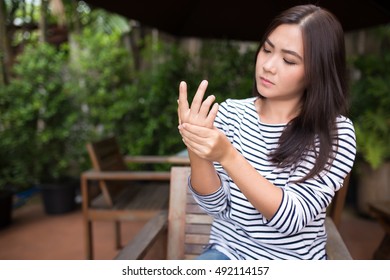 Woman Has Arm Pain At Coffee Shop