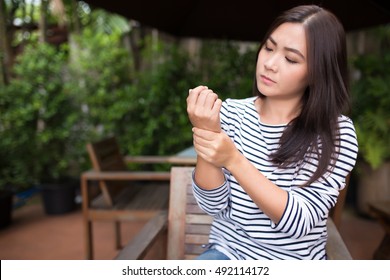 Woman Has Arm Pain At Coffee Shop