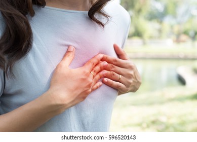 Woman Has Chest Pain Sitting on Bench at Park