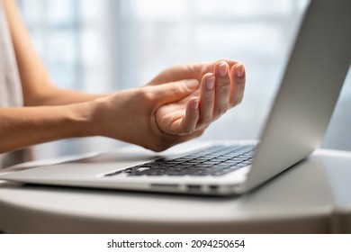 A Woman Has Finger And Hand Pain After Using A Computer For A Long Time. Pain In Wrist While Using Laptop, Carpal Tunnel Syndrome.