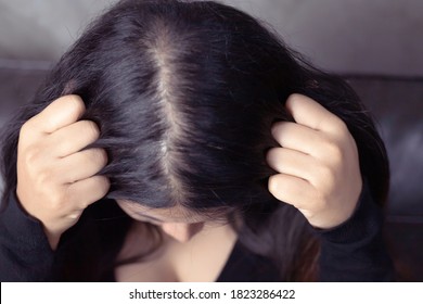 A woman has hair problems, she has hair loss. - Shutterstock ID 1823286422