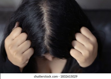 A woman has hair problems, she has hair loss. - Shutterstock ID 1832615029