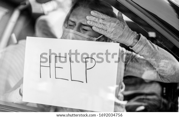 A woman has a headache she asks for help,\
a severe headache is a consequence of the virus in the body. Text\
and word help. Woman car. Problem\
\
