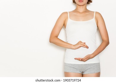 A woman has her hand on her stomach. - Shutterstock ID 1903719724
