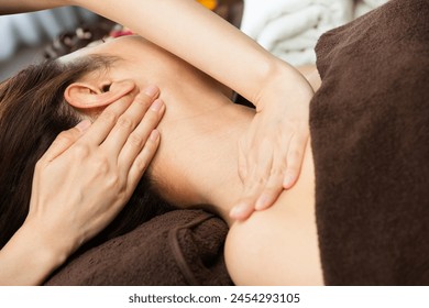 The woman has her neck massaged. - Powered by Shutterstock