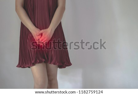 The woman has itching on his genitals.Asian women wear red clothes on their bed, they have itching in the vagina.Girl hands placed at the vagina.Do not focus on objects.