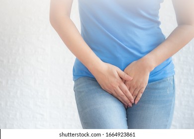 Woman has pain in the genital area and Vaginal on white background,Woman with hands holding her crotch, she wants to pee - urinary incontinence concept