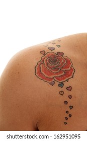 A Woman Has A Rose Tattoo On Her Shoulder.