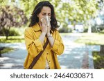 Woman has sneezing. Young woman is having flu and she is sneezing. Sickness, seasonal virus problem concept. Woman being sick having flu sneezing.