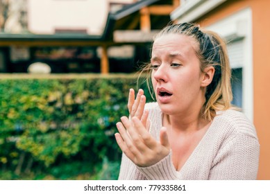 Woman has sneezing. Young woman is having flu and she is sneezing. Sickness, seasonal virus problem concept. Woman being sick having flu sneezing. Fever And Cold. Seasonal influenza and virus. 