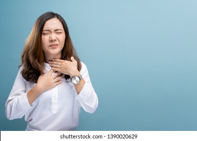 Woman has sore throat isolated over blue background