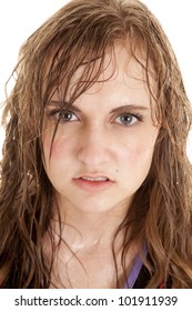 A Woman Has Wet Sweaty Hair And Face With A Serious Expression.