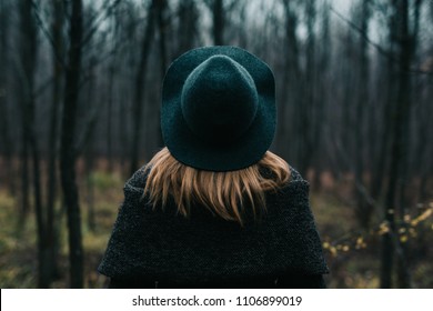 Woman With Hat Looking At The Forest. View From Behind. 