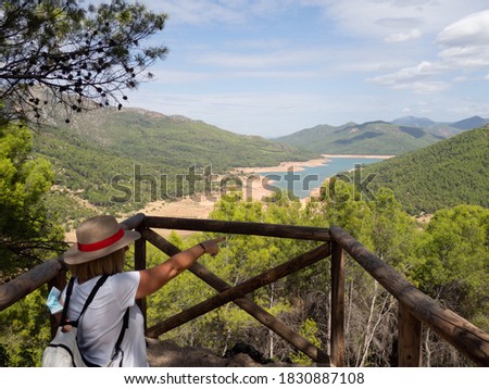 Woman with hat looking towards the Pantano del Tranco from observatories in Cazorla National Park
