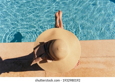 Woman In Hat Near The Pool Top View Rest Sun