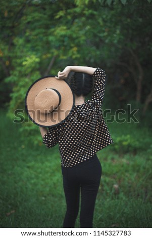 Woman in the hat on nature