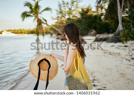  woman with a hat resting on a nature island                              