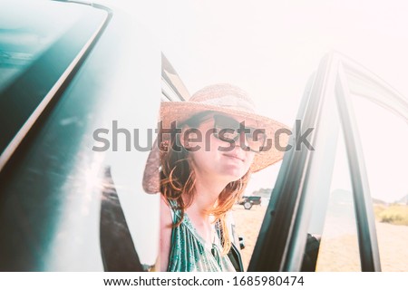 Similar – Happy young woman looking back through the window car