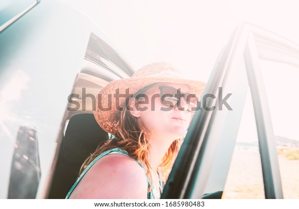 woman with hat in\
summer car and sunny day.\
