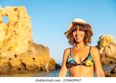 A Woman With A Hat In Summer At Praia Dos Arrifes, Algarve Beach, Albufeira. Portugal