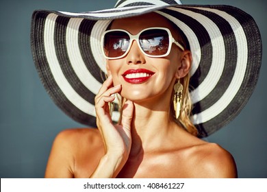 Woman In Hat And Sunglasses